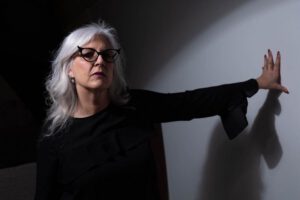 older woman with black cateye glasses