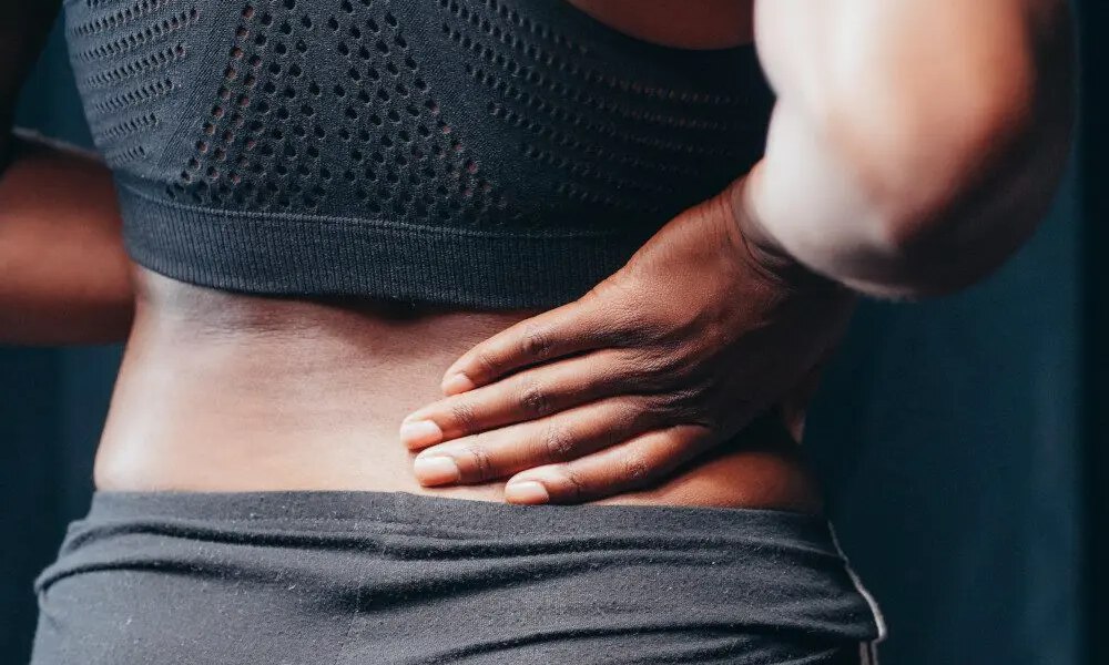 woman holding her back
